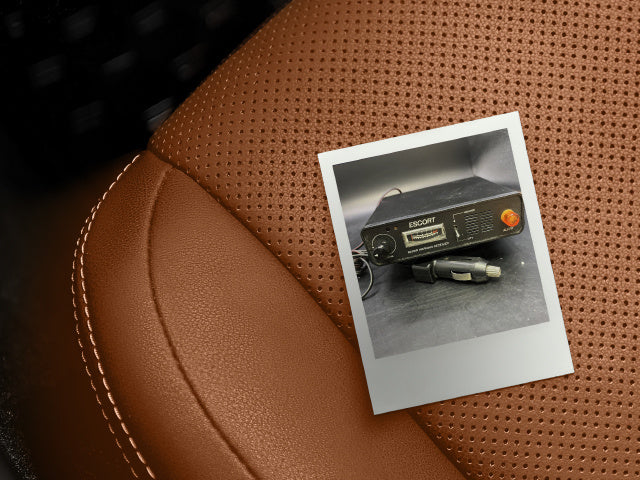 polaroid photo of Escort Radar warning receiver on car seat