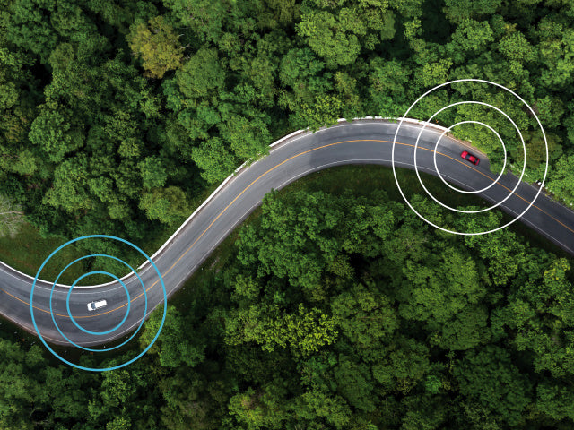 Cars sending signals aerial view winding road